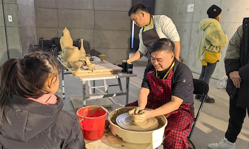 A man makes porcelain at the exhibition in Beijing. Photo: Courtesy of Central Academy of Fine Arts Museum